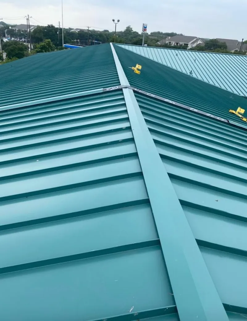 Green commercial metal roof ridge and valley for Metal Roof Repair in Williamsville